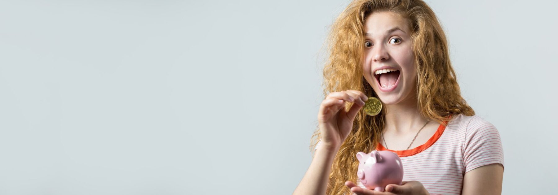 Young,Red-haired,Curly,Girl,Over,White,Background,Holding,Piggy,Bank